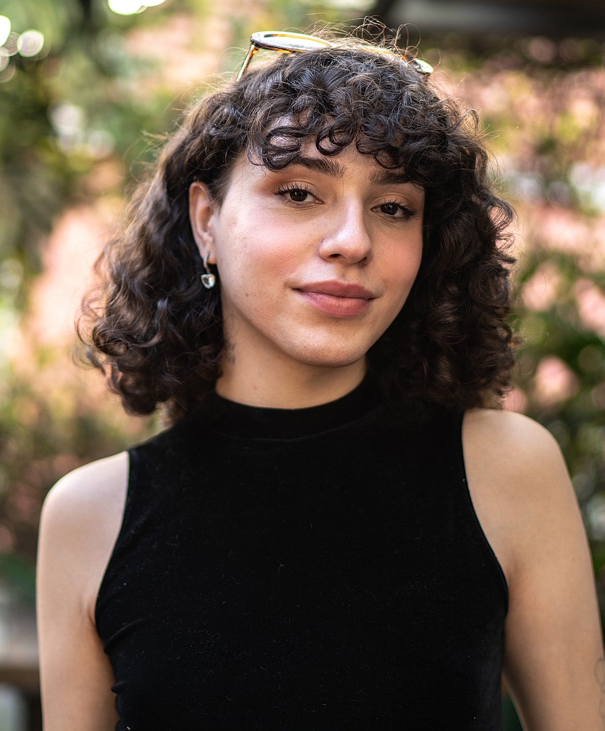 Person with curly hair in outdoor setting.