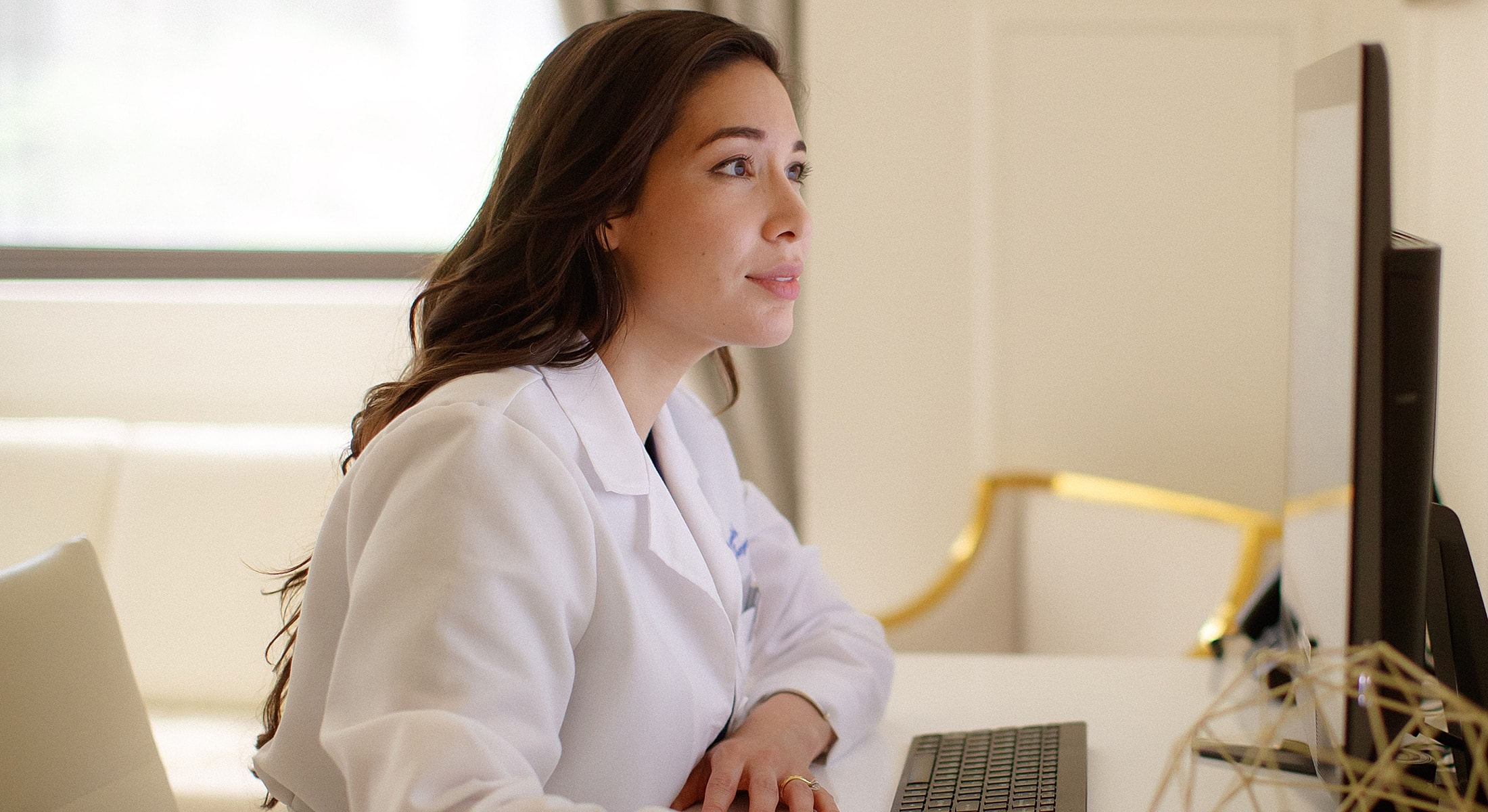 Female doctor working at a computer station.