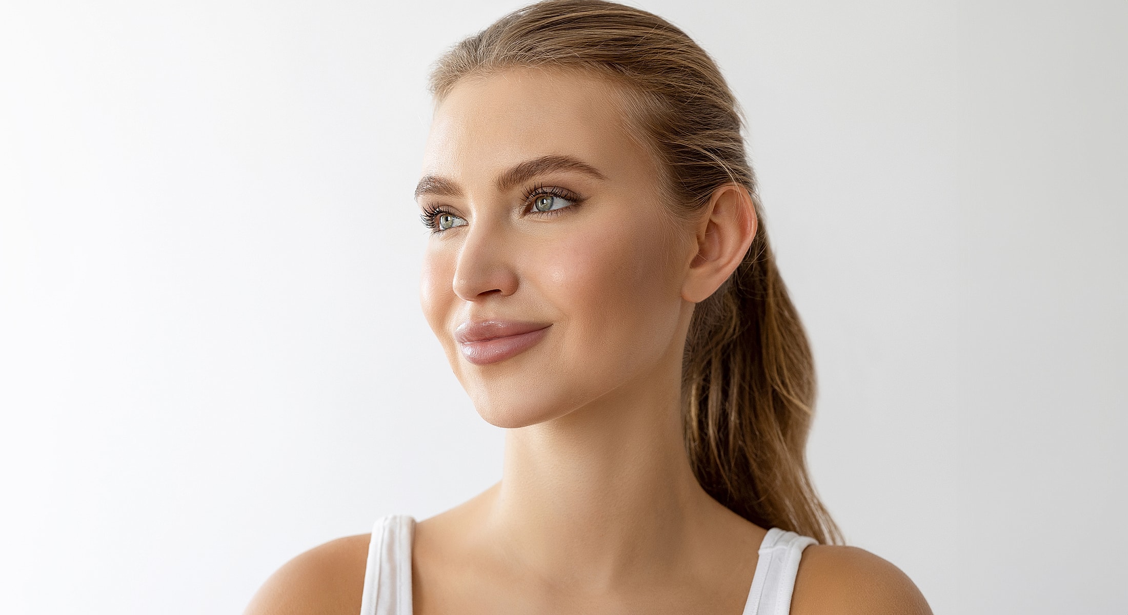 Young woman smiling against a white background